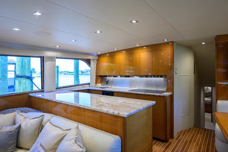 Slide: The Image of Luxurious interior of 2004 Viking 65 Enclosed Bridge yacht with modern kitchen and seating area. - 19