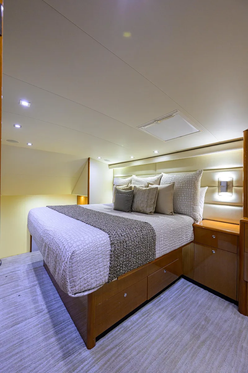 Slide: The Image of Luxurious bedroom interior of 2004 Viking 65 Enclosed Bridge yacht with modern lighting. - 26