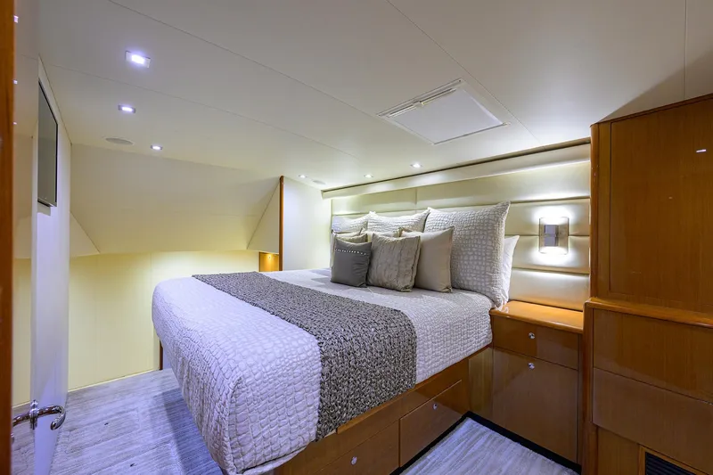 Slide: The Image of Luxurious bedroom interior of 2004 Viking 65 Enclosed Bridge yacht with modern lighting. - 27