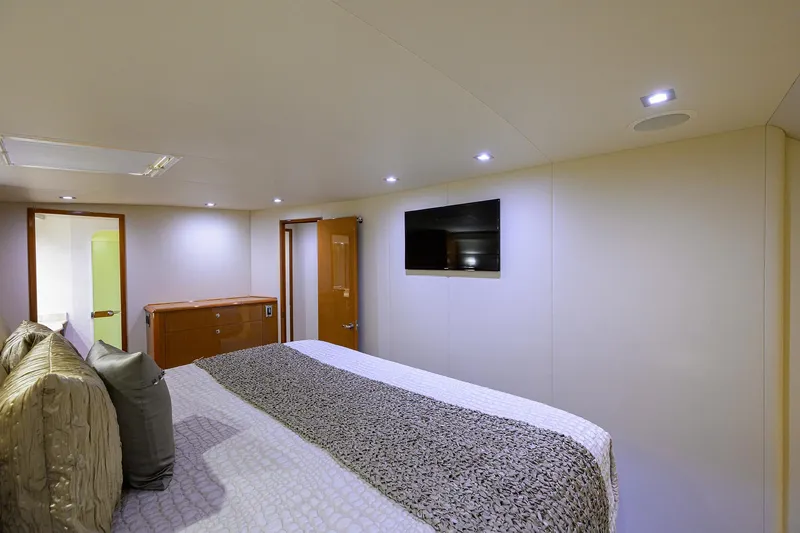 Slide: The Image of Luxurious bedroom interior of 2004 Viking 65 Enclosed Bridge yacht with TV and modern lighting. - 30