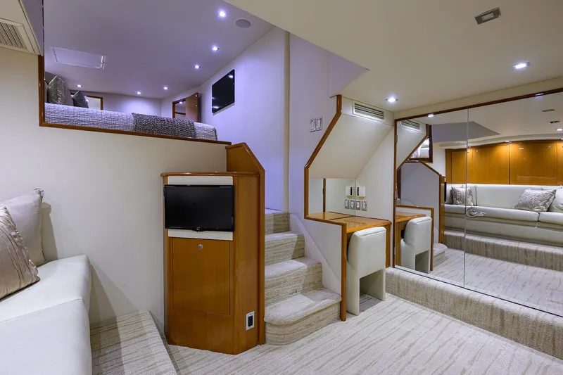 Slide: The Image of Interior of 2004 Viking 65 Enclosed Bridge yacht with modern seating and stairs. - 33