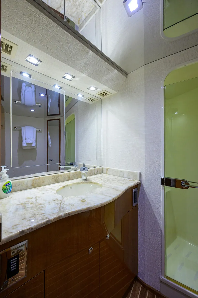 Slide: The Image of Luxurious bathroom on 2004 Viking 65 Enclosed Bridge yacht with marble countertop and shower. - 36
