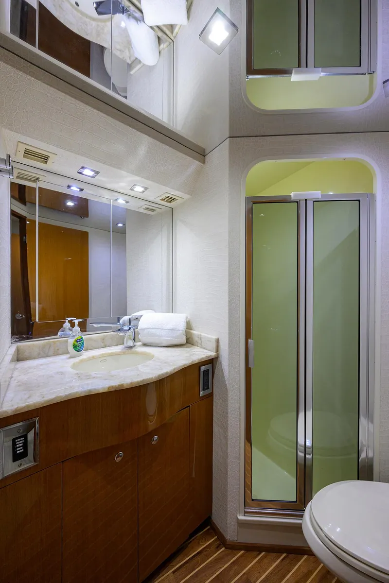 Slide: The Image of 2004 Viking 65 Enclosed Bridge yacht bathroom with shower, vanity, and mirror. - 45