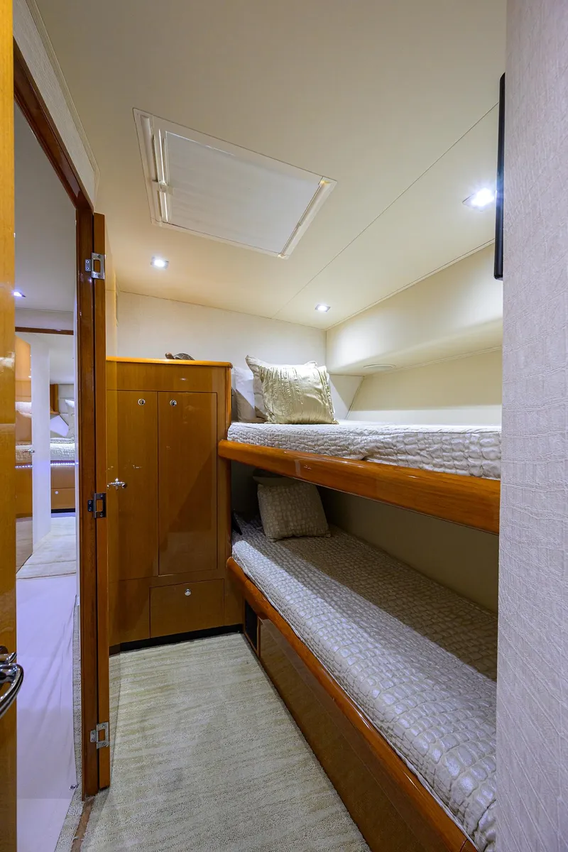 Slide: The Image of 2004 Viking 65 Enclosed Bridge w/Tower bunk bed cabin interior - 47