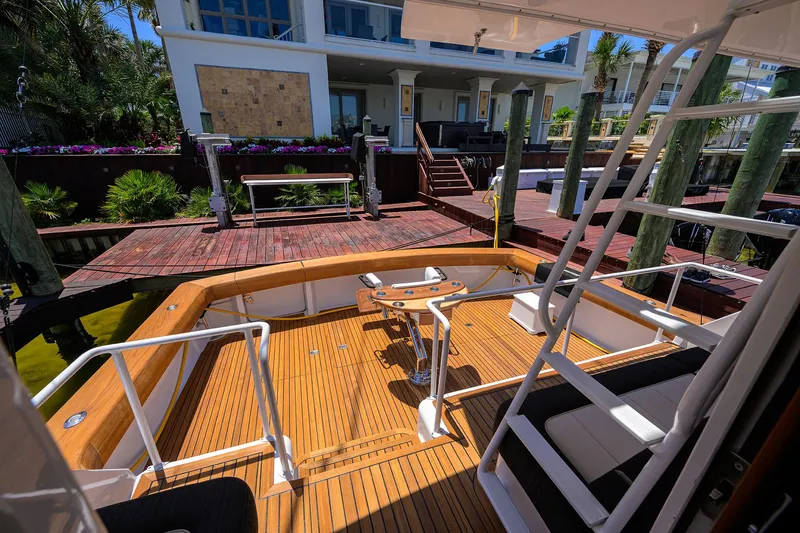 Slide: The Image of 2004 Viking 65 Enclosed Bridge w/Tower yacht docked at a wooden pier. - 5