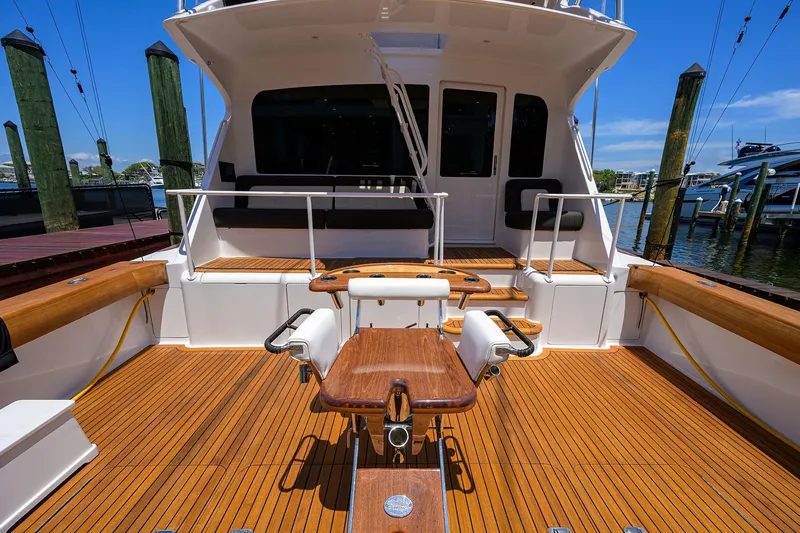 Slide: The Image of 2004 Viking 65 Enclosed Bridge w/Tower, spacious teak deck, fishing chair, docked at marina. - 7