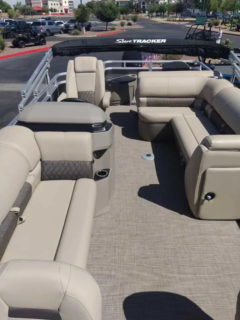 Slide: The Image of 2024 Sun Tracker Fishin' Barge 20 DLX pontoon boat with spacious seating and modern design. - 2