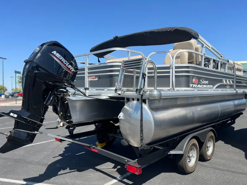 Slide: The Image of 2024 Sun Tracker Fishin' Barge 20 DLX pontoon boat with Mercury outboard motor. - 5