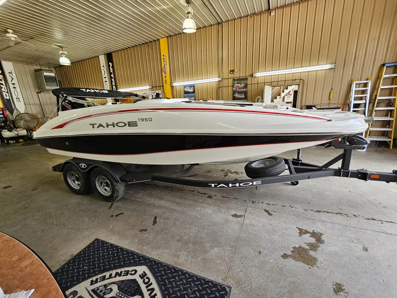 Slide: The Image of 2024 Tahoe 1950 boat on trailer in indoor storage facility. - 0