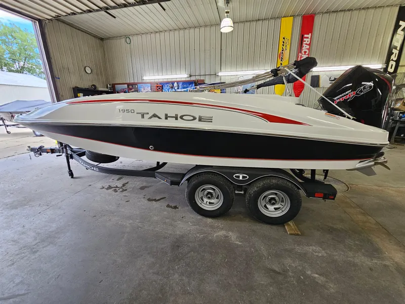 Slide: The Image of 2024 Tahoe 1950 boat in a garage, side view. - 1