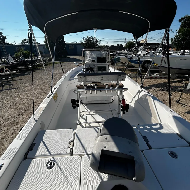 Slide: The Image of 2008 Skeeter ZX2250 boat with canopy, docked in a marina. - 10