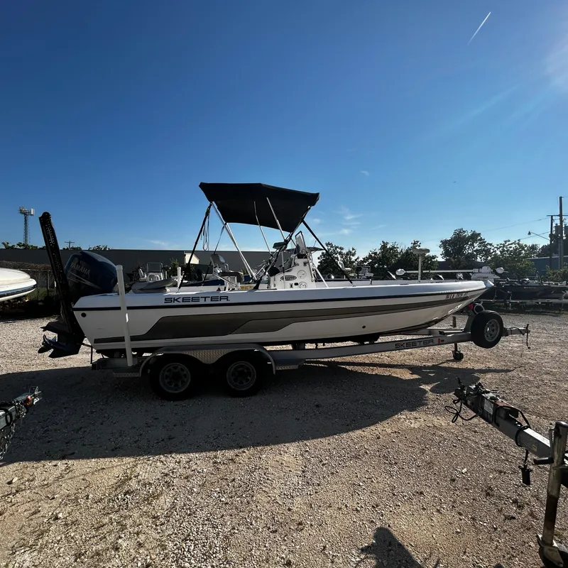 Slide: The Image of 2008 Skeeter ZX2250 boat on a trailer under a clear blue sky. - 5