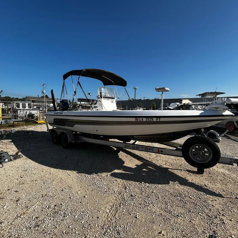 Slide: The Image of 2008 Skeeter ZX2250 boat on a trailer in a marina. - 6