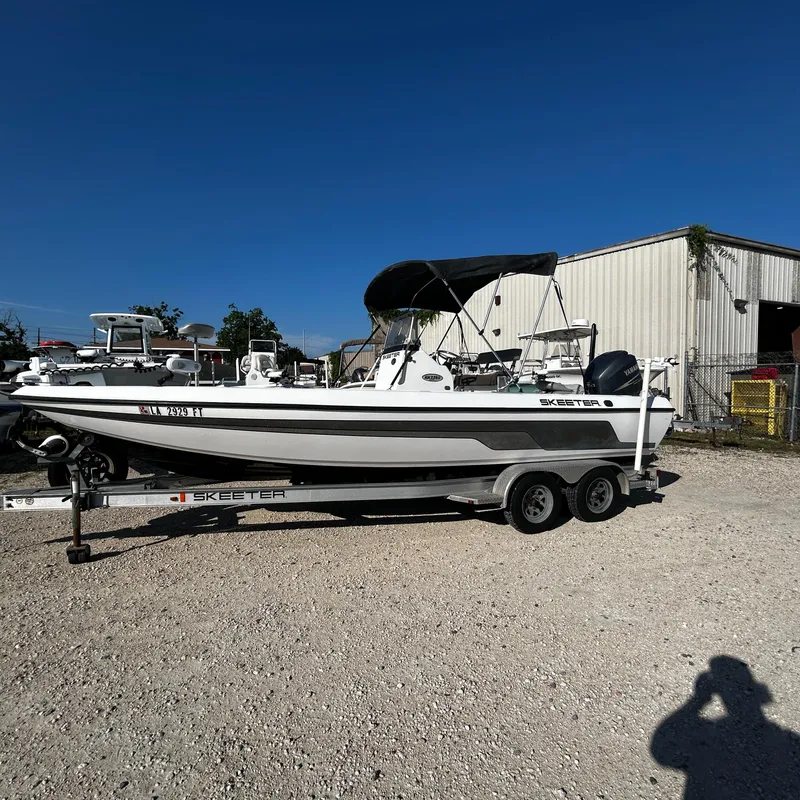 Slide: The Image of 2008 Skeeter ZX2250 boat on a trailer in a gravel lot. - 9