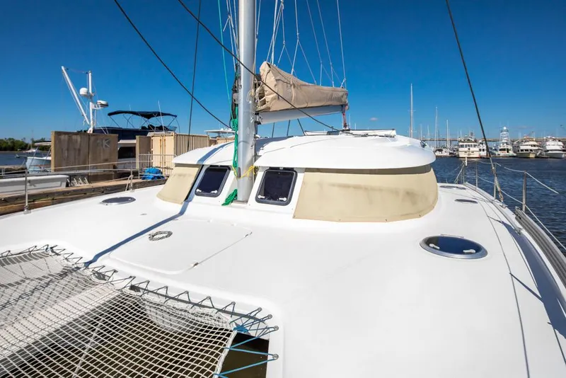 Slide: The Image of 2013 Fountaine Pajot Lipari 41 catamaran docked at marina under clear blue sky. - 22