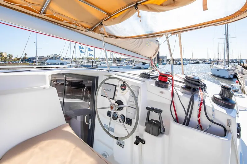 Slide: The Image of Cockpit of 2013 Fountaine Pajot Lipari 41 catamaran with steering wheel and marina view. - 34