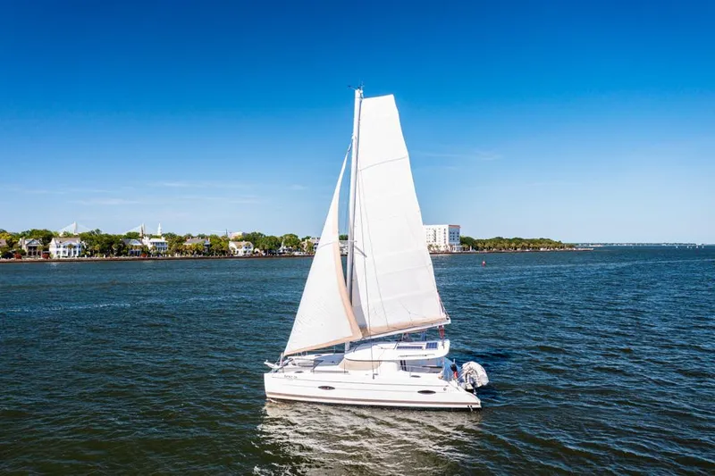 Slide: The Image of Sailing catamaran Fountaine Pajot Lipari 41, 2013 model, on open water under clear blue sky. - 4
