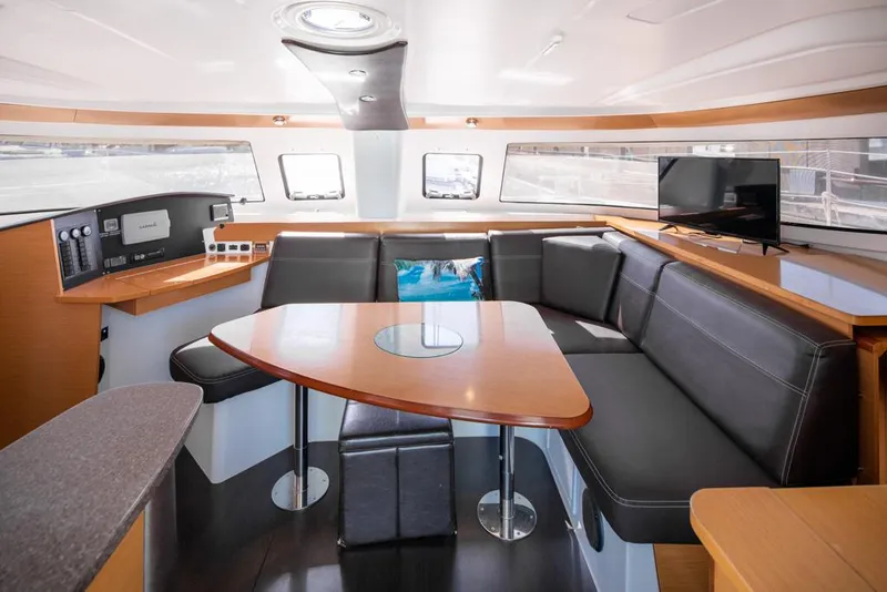 Slide: The Image of Interior of 2013 Fountaine Pajot Lipari 41 catamaran with modern seating and navigation equipment. - 42