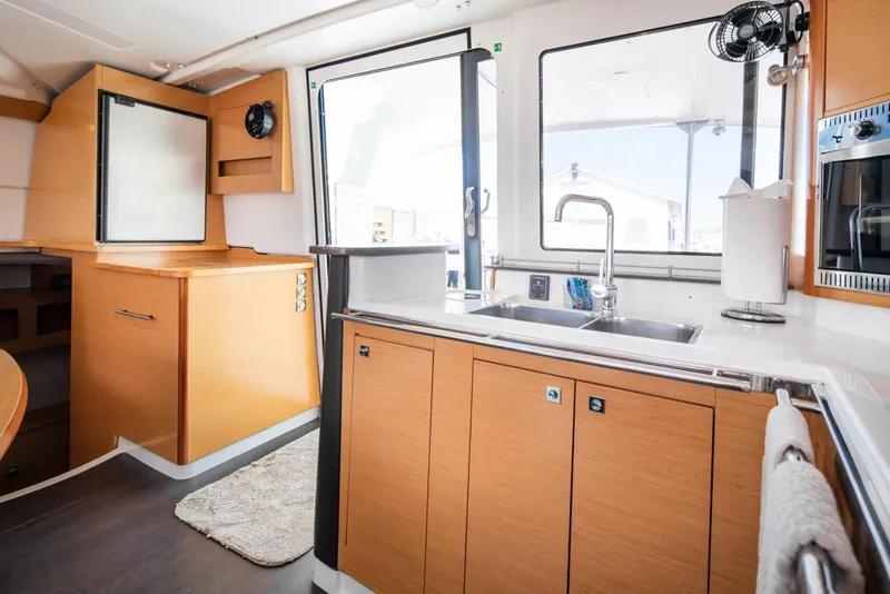 Slide: The Image of Modern kitchen interior of 2013 Fountaine Pajot Lipari 41 catamaran with wood cabinetry and stainless steel sink. - 47