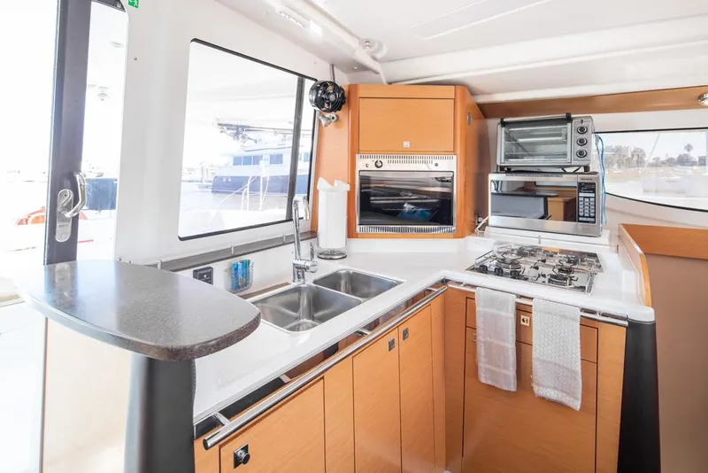 Slide: The Image of Modern kitchen interior of 2013 Fountaine Pajot Lipari 41 catamaran with appliances and wood cabinetry. - 49