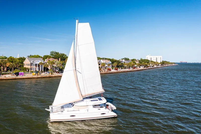 Slide: The Image of Sailing catamaran Fountaine Pajot Lipari 41, 2013, cruising near a scenic coastal town. - 5