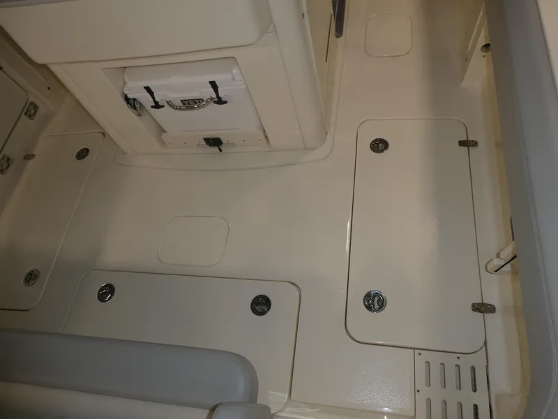Slide: The Image of 2024 Scout 305 LXF boat interior deck with storage compartments. - 10