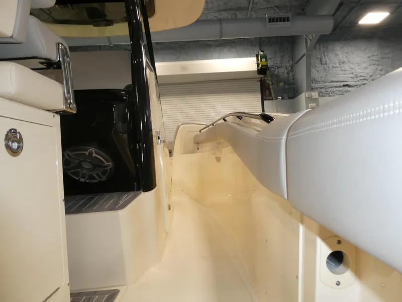 Slide: The Image of 2024 Scout 305 LXF boat interior, side view with seating and storage compartments. - 11