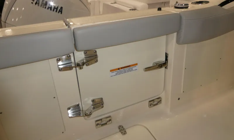 Slide: The Image of 2024 Scout 305 LXF boat interior with cushioned seating and storage compartment. - 13