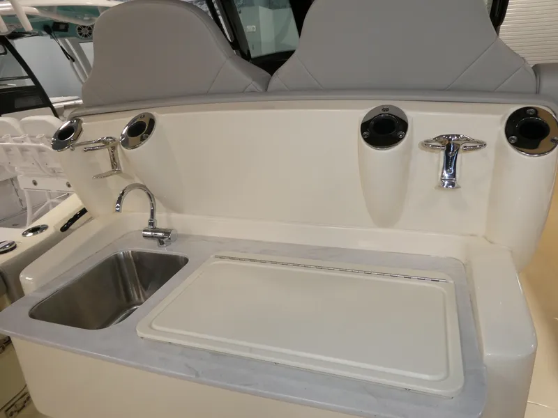 Slide: The Image of 2024 Scout 305 LXF boat interior with sink and cutting board. - 14