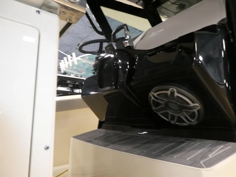 Slide: The Image of 2024 Scout 305 LXF boat interior with steering wheel and speaker system. - 15