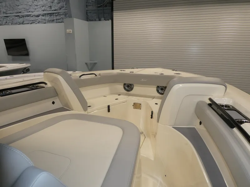 Slide: The Image of 2024 Scout 305 LXF boat interior with cushioned seating and modern design. - 19