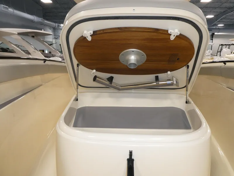 Slide: The Image of 2024 Scout 305 LXF boat storage compartment with open lid. - 21