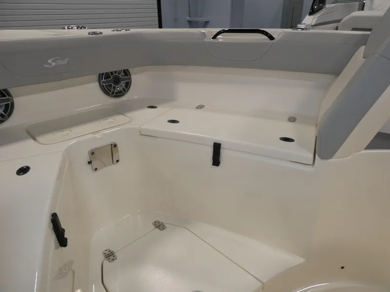 Slide: The Image of 2024 Scout 305 LXF boat interior with seating and storage compartments. - 26