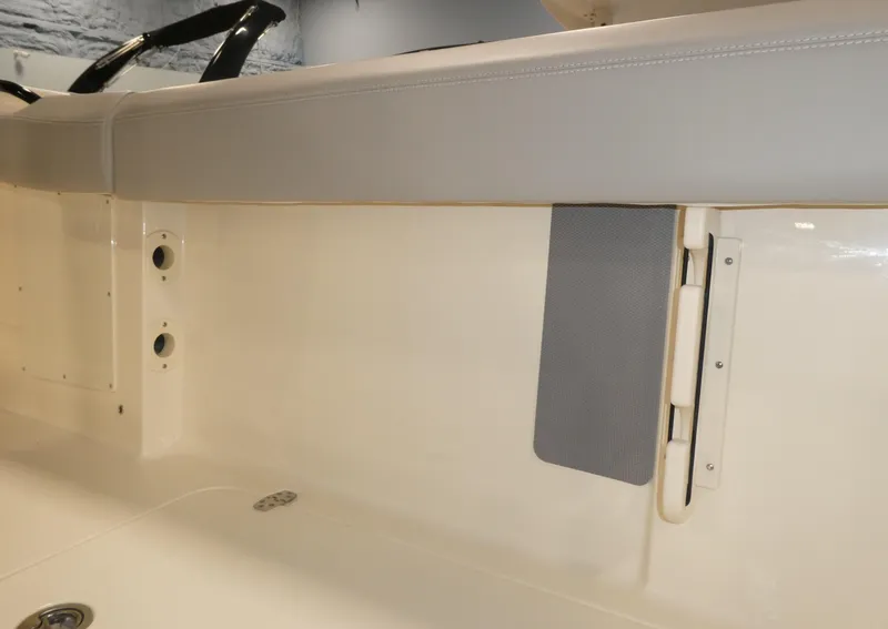 Slide: The Image of 2024 Scout 305 LXF boat interior detail with beige and gray upholstery. - 28
