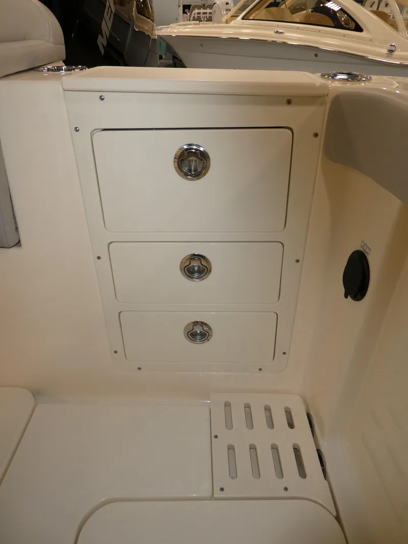 Slide: The Image of 2024 Scout 305 LXF boat storage compartments and seating area. - 32