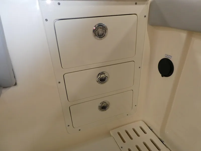 Slide: The Image of 2024 Scout 305 LXF boat storage drawers and compartment. - 33
