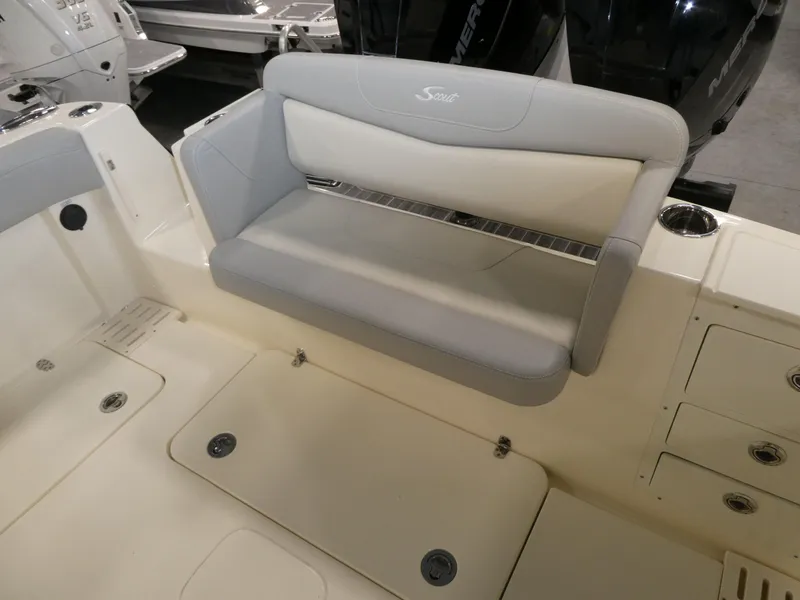 Slide: The Image of 2024 Scout 305 LXF boat interior with cushioned seating and storage compartments. - 34