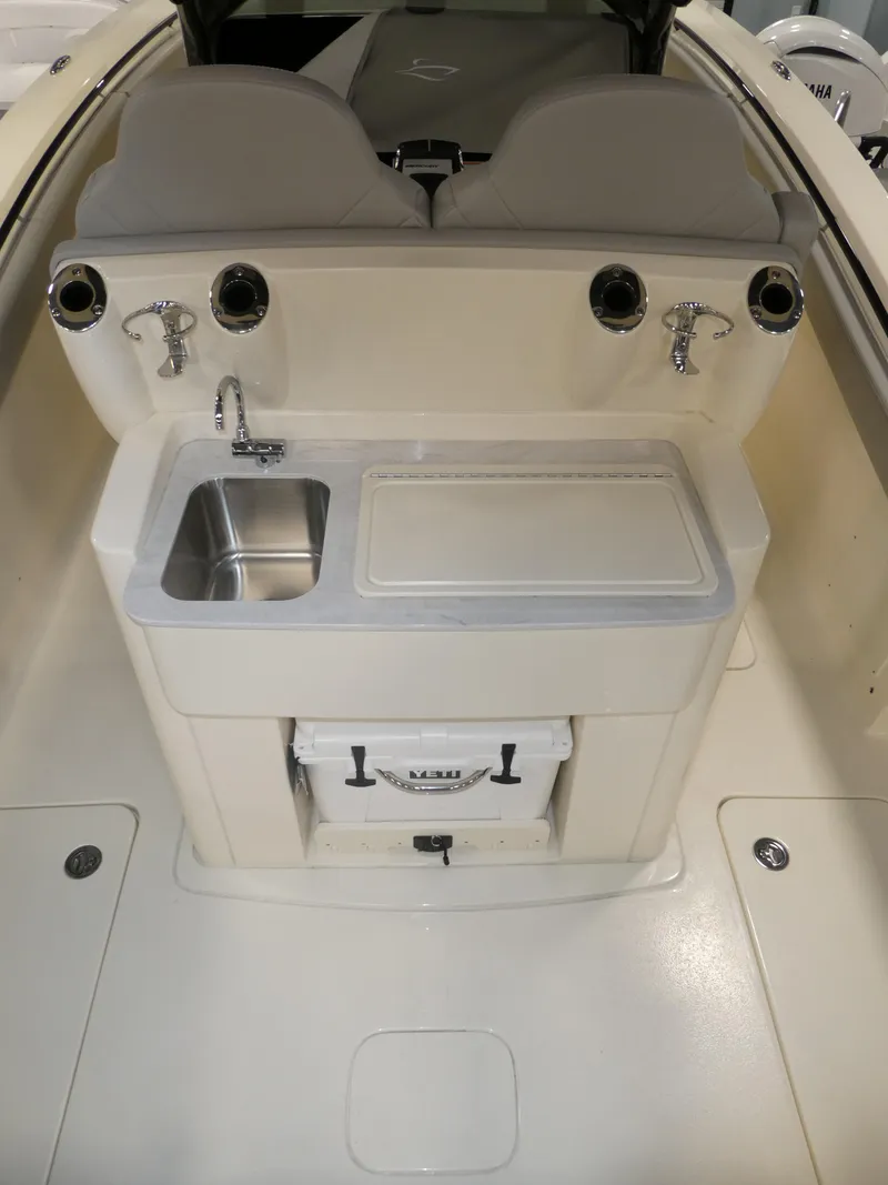 Slide: The Image of 2024 Scout 305 LXF boat with sink and cooler in cockpit. - 37