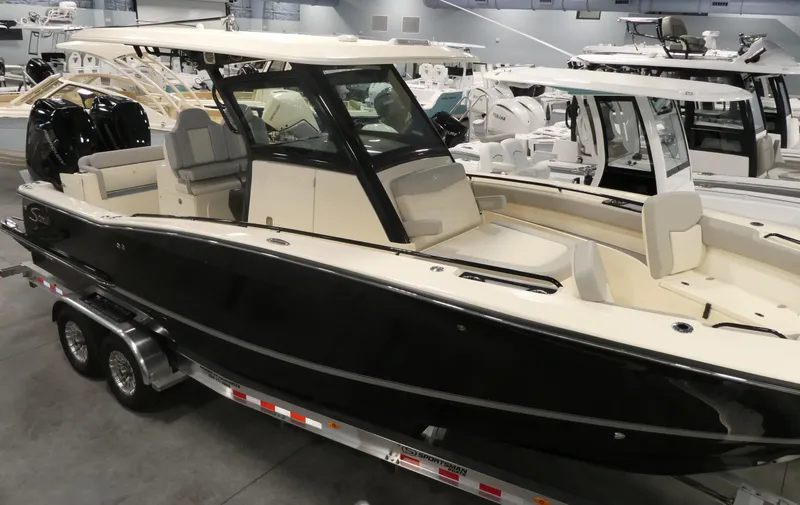 Slide: The Image of 2024 Scout 305 LXF boat on trailer in showroom. - 4