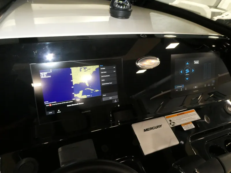 Slide: The Image of 2024 Scout 305 LXF boat dashboard with navigation and control screens. - 40