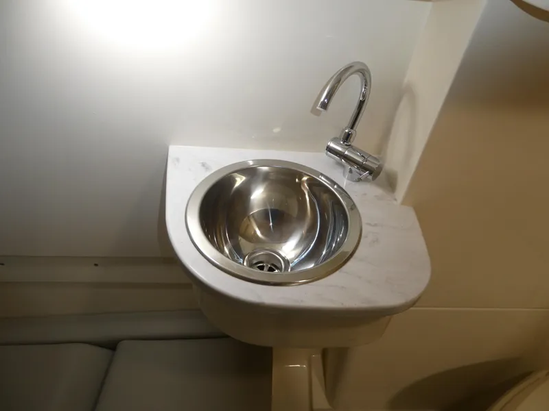 Slide: The Image of 2024 Scout 305 LXF boat bathroom sink with modern faucet. - 45