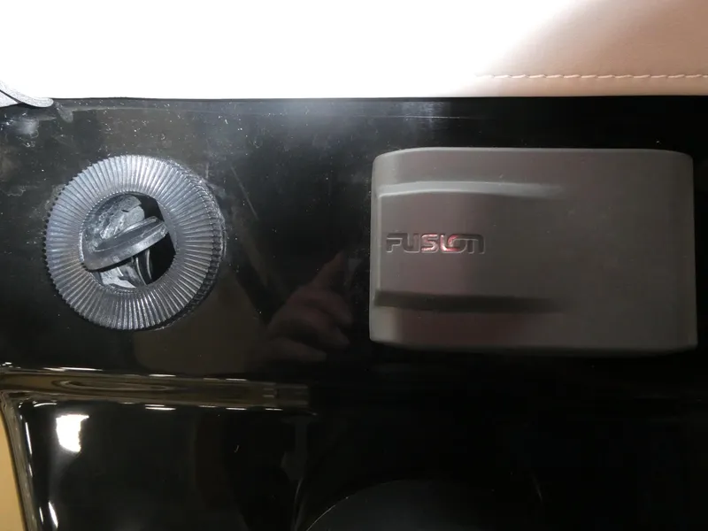 Slide: The Image of Close-up of 2024 Scout 305 LXF boat's Fusion audio system control. - 52