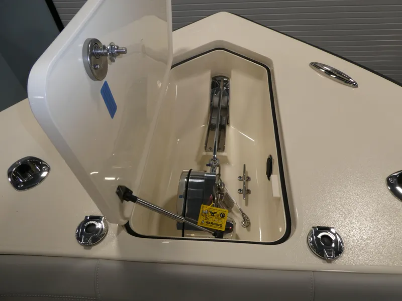 Slide: The Image of 2024 Scout 305 LXF boat anchor compartment with open hatch. - 53