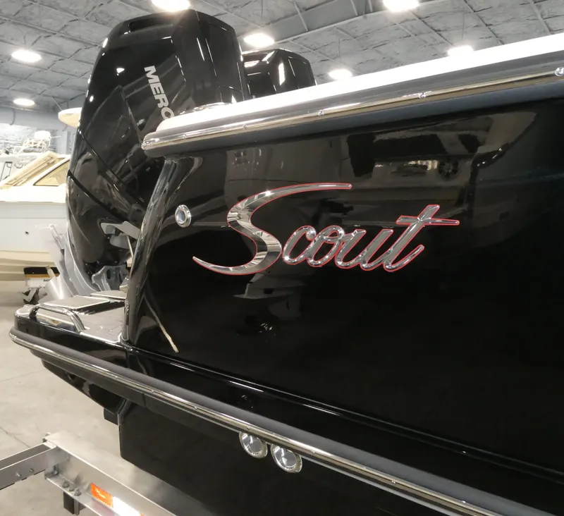 Slide: The Image of 2024 Scout 305 LXF boat with Mercury engine in showroom. - 7
