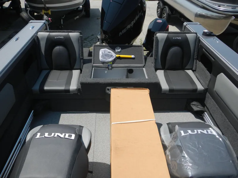 Slide: The Image of 2024 Lund 2075 Tyee boat interior with seating and fishing equipment. - 10
