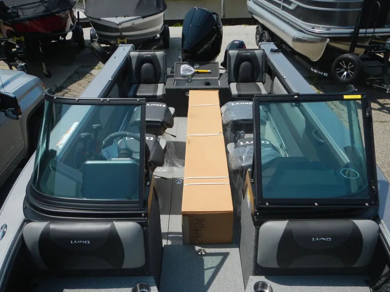 Slide: The Image of 2024 Lund 2075 Tyee boat interior with windshield and seating. - 3