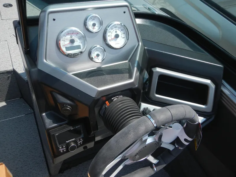 Slide: The Image of 2024 Lund 2075 Tyee boat dashboard with steering wheel and instrument panel. - 4