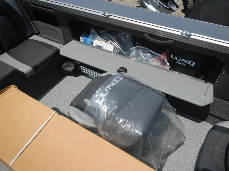 Slide: The Image of Interior of 2024 Lund 2075 Tyee boat with seating and storage compartments. - 6