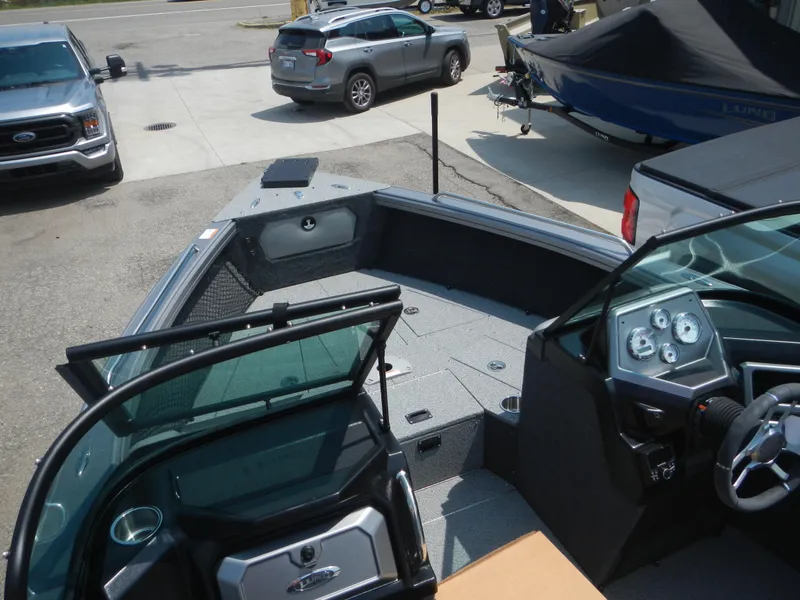 Slide: The Image of 2024 Lund 2075 Tyee boat interior with dashboard and seating area. - 8