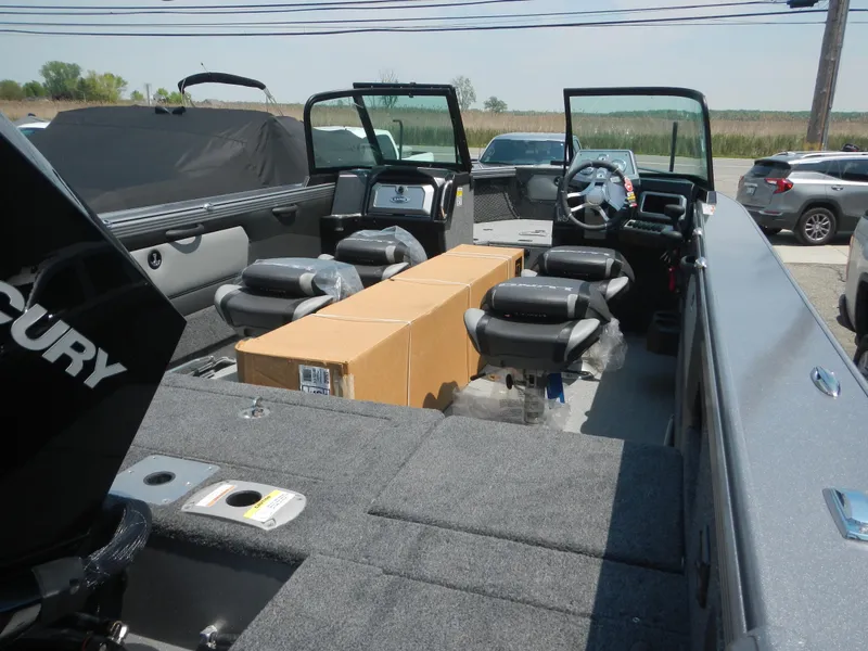 Slide: The Image of 2024 Lund 2075 Tyee boat interior with Mercury engine and seating arrangement. - 9